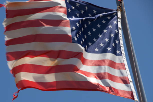 istock the American flag is flying in a strong wind 972098804