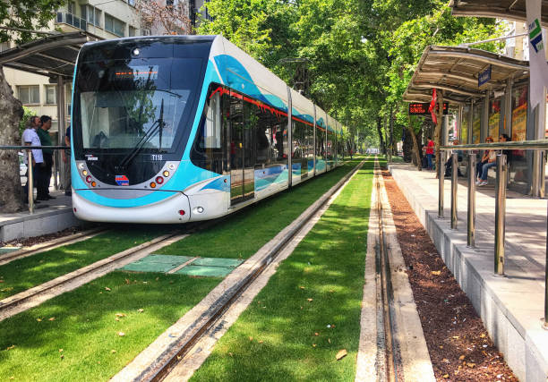 A tram is a rail vehicle which runs on tramway tracks along public urban streets, and also sometimes on a segregated right of way. Izmir is a metropolitan city in the western extremity of Anatolia and the third most populous city in Turkey. People in the image are passengers of tram.