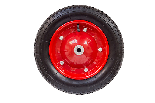 Red wheel with a protector for country cart, isolated on a white background.