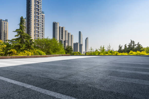 istock Panoramic skyline and modern business office buildings with empty road,empty concrete square floor 972137852