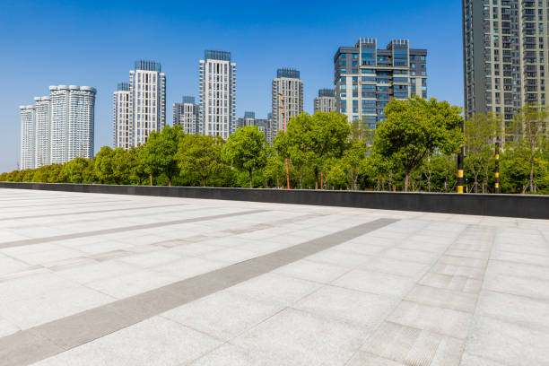 istock Panoramic skyline and modern business office buildings with empty road,empty concrete square floor 972141082