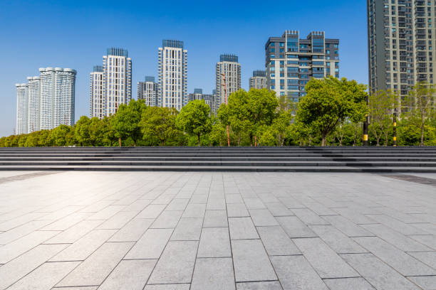 istock Panoramic skyline and modern business office buildings with empty road,empty concrete square floor 972141086