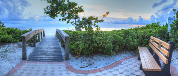 istock Bench overlooks a wooden boardwalk onto Naples Beach 972142032