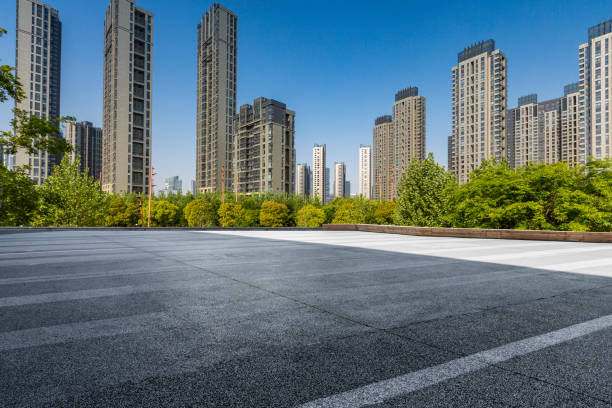 istock Panoramic skyline and modern business office buildings with empty road,empty concrete square floor 972144734