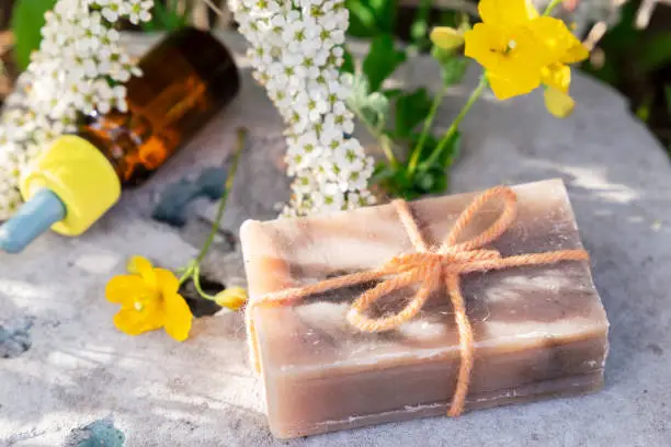 Natural soap homemade with essential oil in dark bottle summer aroma