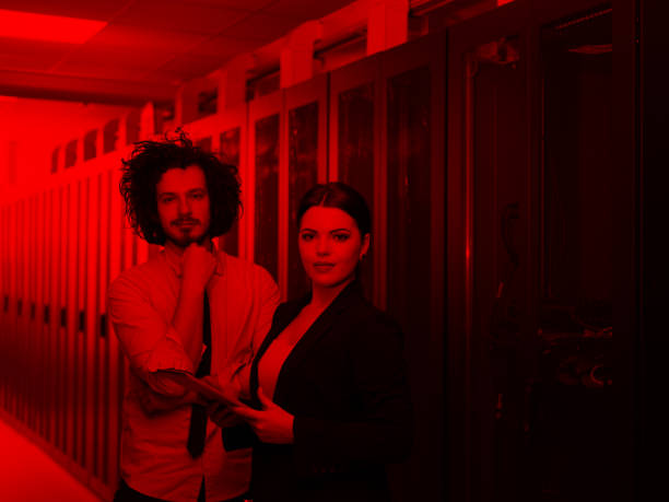 istock engineer showing working data center server room to female chief 972148140