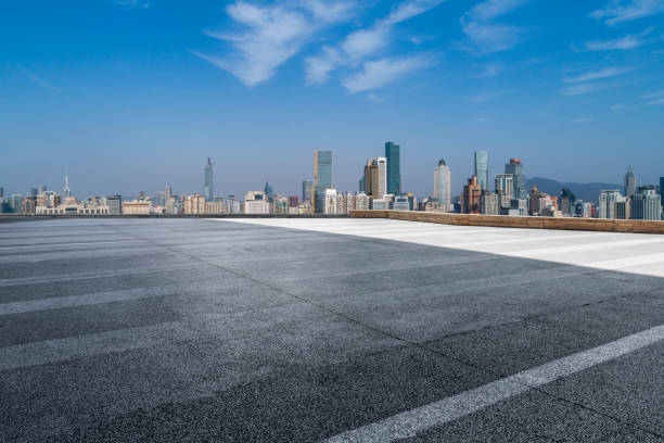 istock Panoramic skyline and modern business office buildings with empty road,empty concrete square floor 972150738