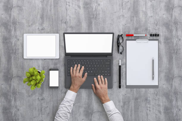 Man working on laptop knolling overhead view