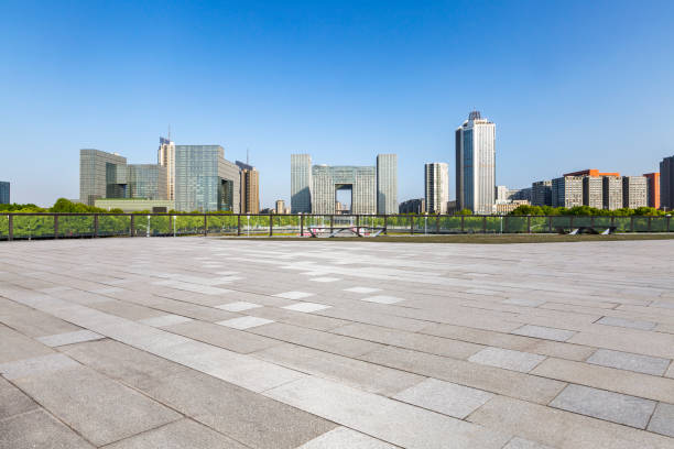 istock Panoramic skyline and modern business office buildings with empty road,empty concrete square floor 972151070