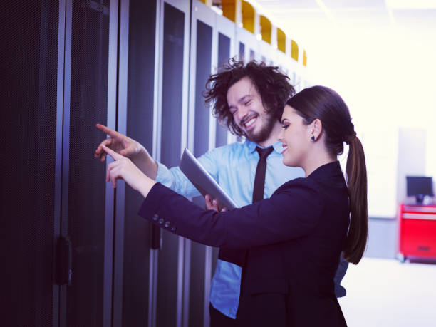 istock engineer showing working data center server room to female chief 972151786