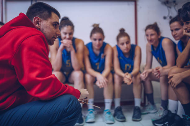 istock Coach talking to basketball team 972154254