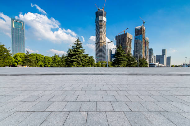 istock Panoramic skyline and modern business office buildings with empty road,empty concrete square floor 972154346
