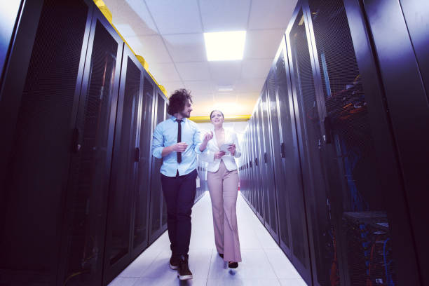 istock engineer showing working data center server room to female chief 972155174