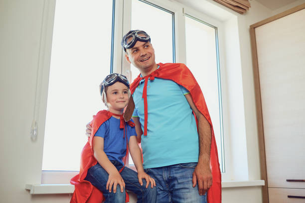 istock Father and son at the window in the room 972155566