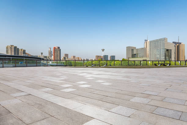 istock Panoramic skyline and modern business office buildings with empty road,empty concrete square floor 972158036