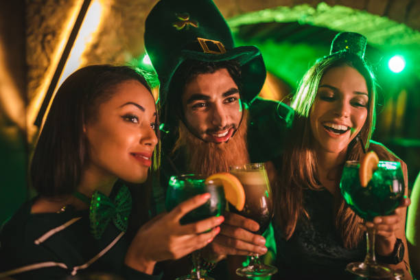istock Multi-ethnic friends drinking beer and cocktails on Saint Patrick's day 972158360