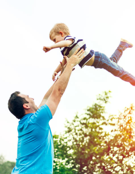 istock Father throwing child in the air 972162184