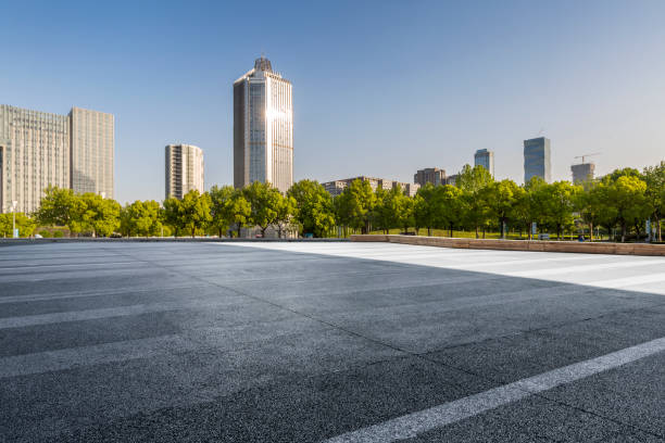 istock Panoramic skyline and modern business office buildings with empty road,empty concrete square floor 972165530