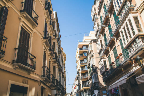 istock low angle view of buildings on street, spain 972170628