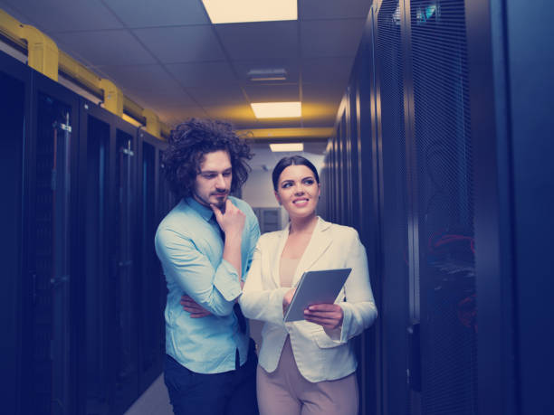 istock engineer showing working data center server room to female chief 972171064