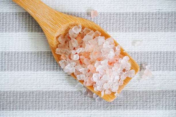 istock Close up himalayan pink salt in the spoon on the table. 972173550