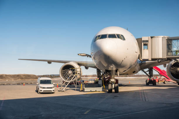 istock Large passenger plane parked on runway with connect a aisles 972176868