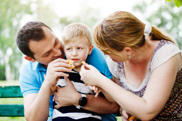 istock Parents trying to make their son eat 972176948