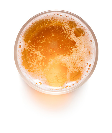 top view of glass of lager beer isolated on white background