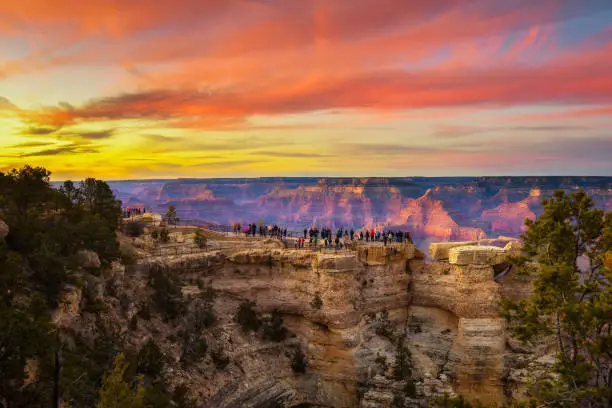 Tourists enjoy  beautiful sunset above Grand Canyon National Park from point of view named Mather Point.