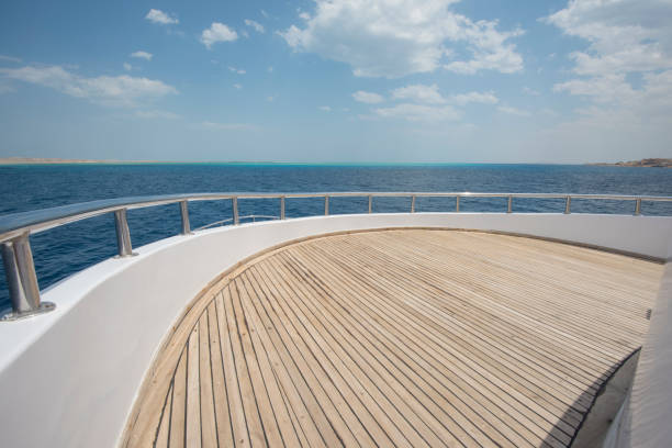 View over the bow of a large luxury motor yacht on tropical open ocean