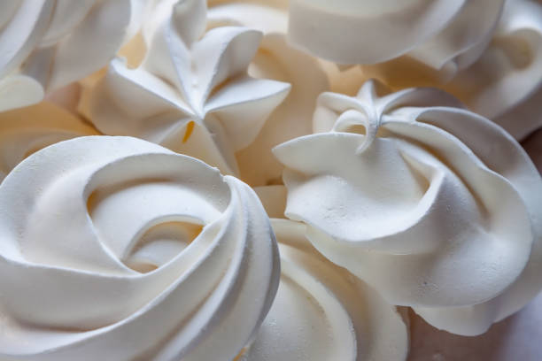 White meringue - simple summer dessert. Close up sweet gourmet food - white meringue foreground wedding cake close up macro stock pictures, royalty-free photos & images