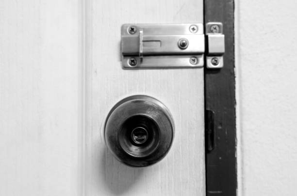 istock Padlock on weathered white door 972194056