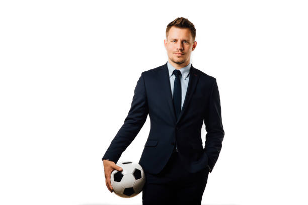 joven guapo empresario sosteniendo un balón de fútbol aislado sobre el estudio de fondo blanco - suit soccer men sport fotografías e imágenes de stock