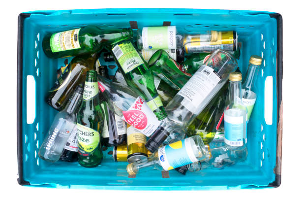 Close-up on a worker sorting bottles at a recycling factory - environmental concepts