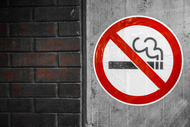 Smoking is not allowed sign on a concrete wall Smoking is not allowed sign on a concrete wall, brick wall on left letter f photos stock pictures, royalty-free photos & images