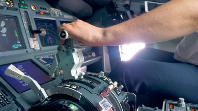 Throttle lever is getting pulled by a pilot of an aircraft