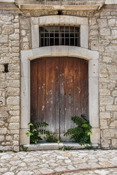istock Medieval wooden door, adorned with stone 972240122
