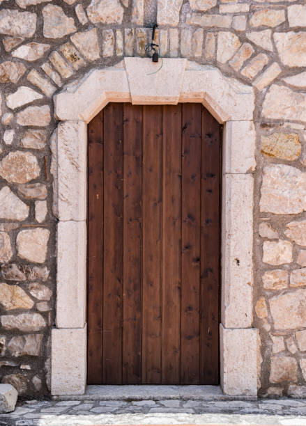 istock Medieval wooden door, adorned with stone 972245862