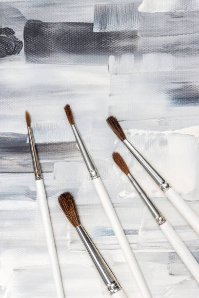 istock Paint brushes on black and white artistic background 972250036