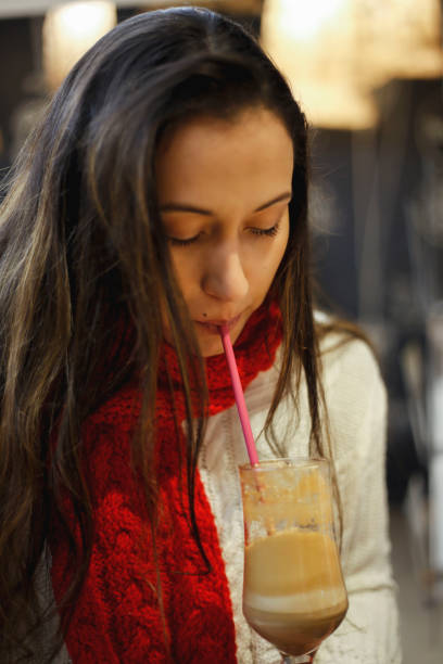 istock Young woman drinking coffe in cafe 972250152