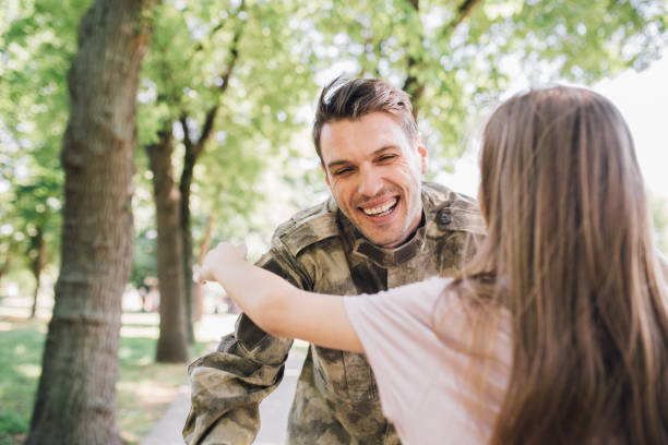 istock Soldier hugging daughter 972250532