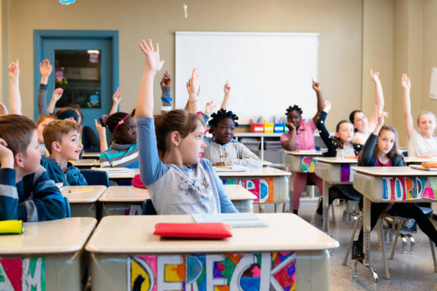 istock Multi-ethnic students sit into the class for the first day at school 972257718