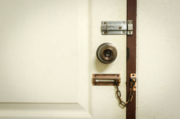 istock Padlock on weathered white door 972291468