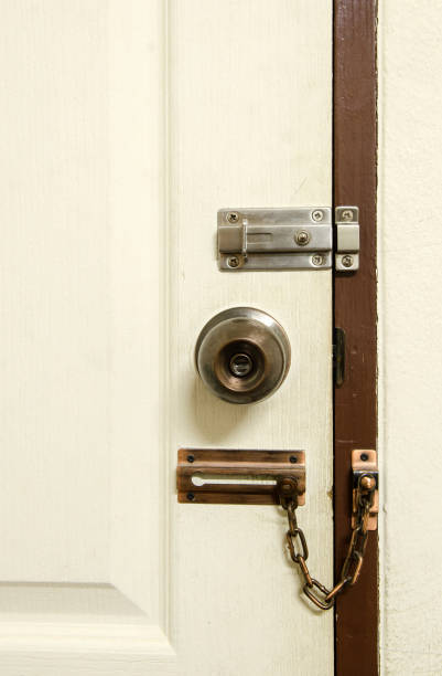 istock Padlock on weathered white door 972291470