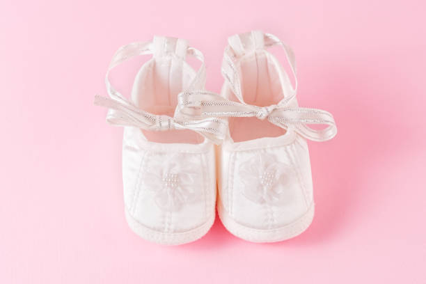 istock Baby shoes on pink background 972301442