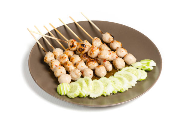 istock Meatballs in sauce with fresh vegetable isolated on white background 972301752
