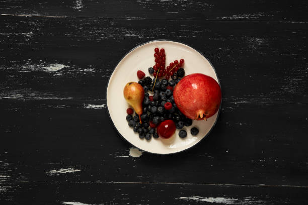 Fruits and berries lying on round plate