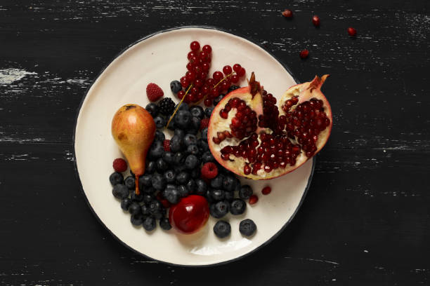 Fruits and berries lying on round plate