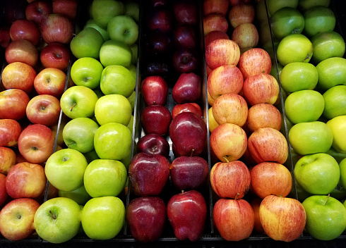 Grocery shop theme. Fresh colorful apple background. Row of clean apple