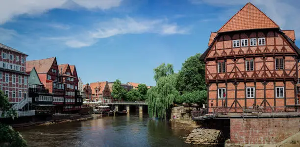 Half-timbered red bricks houses near the river at the old harbor of Luneburg, Germany.